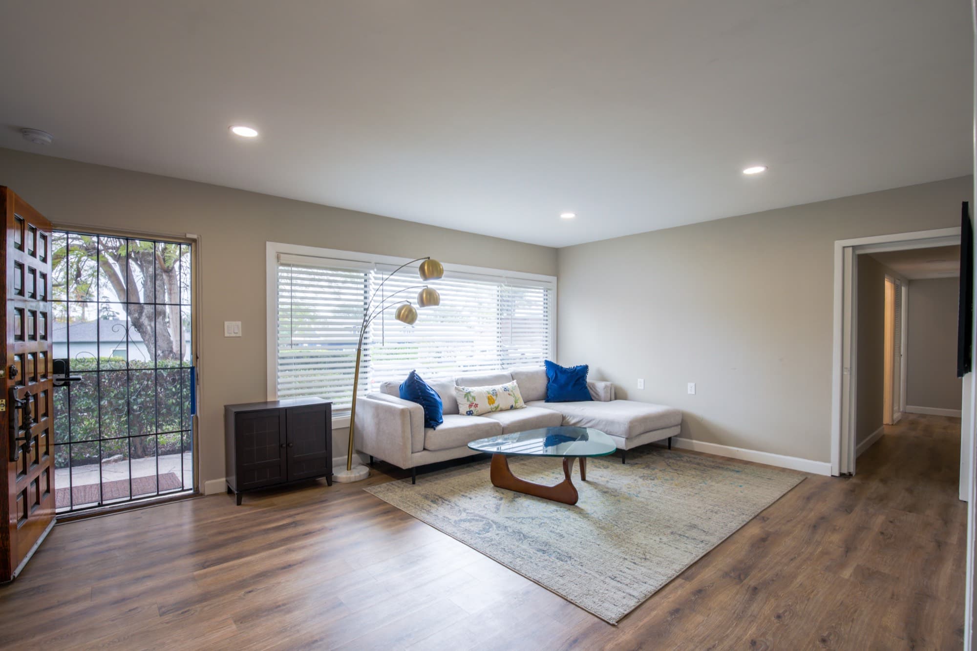 Spacious living room with sectional sofa and natural light through front entry